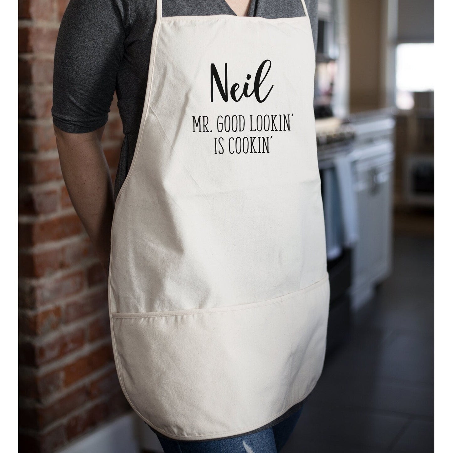 https://sweethooligans.design/cdn/shop/products/mr-good-lookin-is-cookin-grilling-apron-funny-kitchen-apron-for-dad-fathers-day-apron-gift-bbq-grill-gift-for-dad-personalized-171977_1445x.jpg?v=1668884496
